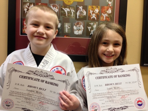 Laney and her big-brother Landon, holding their Brown Belt Certifications. She smiles and on the inside, she is screaming!